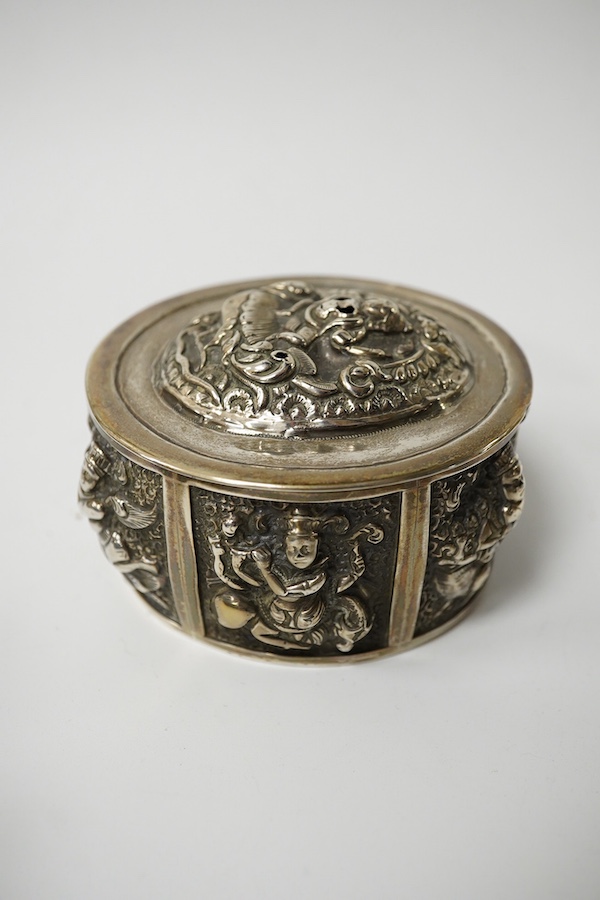 An Edwardian rectangular embossed silver mounted note case, leather lined, Goldsmiths & Silversmiths Co Ltd, London, 1901, 10.3cm, an oval silver tea caddy and cover and an Indian white metal circular box. Condition - po